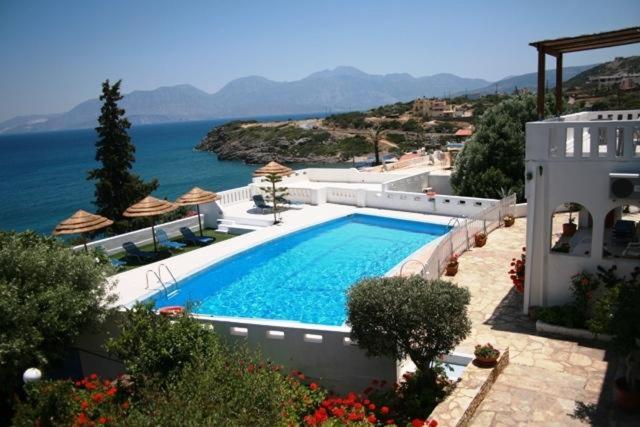 a large swimming pool in front of a house at Residence Gerani in Agios Nikolaos