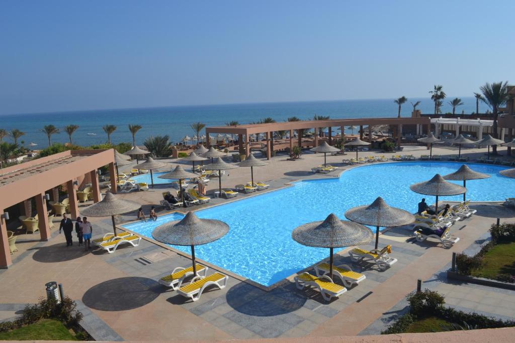 an overhead view of a resort swimming pool with umbrellas at Romance Hotel & Aqua Park in Ain Sokhna