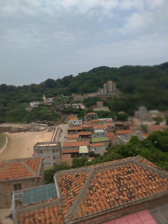 a view of a town with a beach and buildings at mei hao min su in Nangan