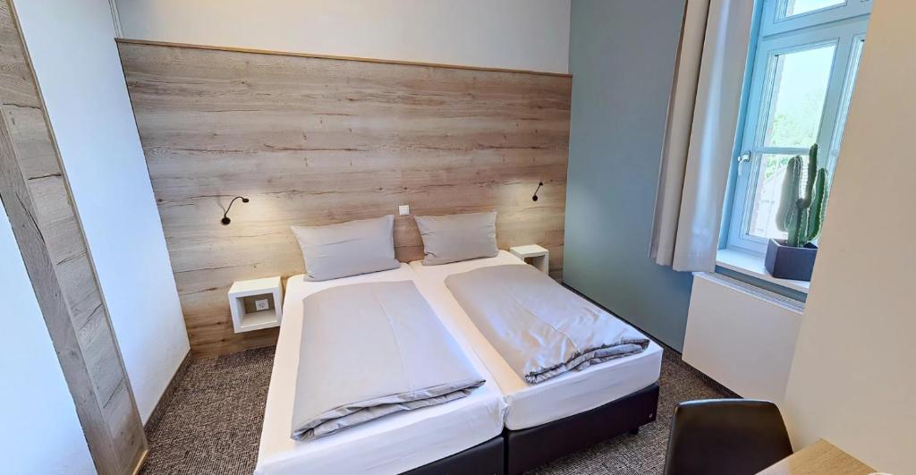 Postel nebo postele na pokoji v ubytování Boardinghouse Emden