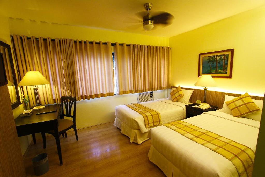 Postel nebo postele na pokoji v ubytování Hotel Fleuris