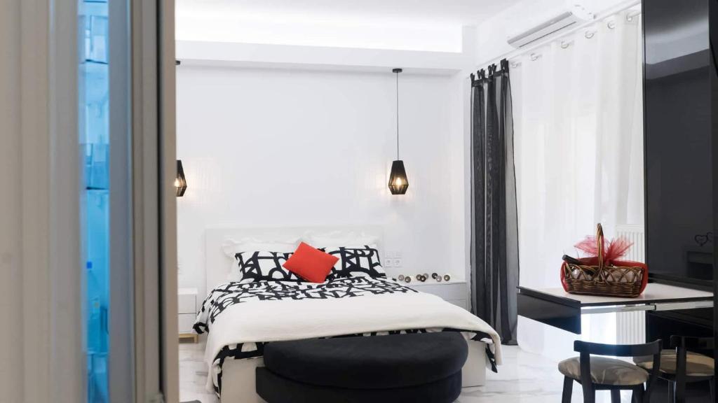 una camera con letto bianco e nero e scrivania di Affordable luxury studio close to Ampelokipi metro ad Atene