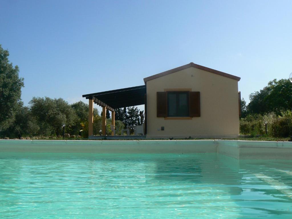 una casa con piscina di fronte a una casa di B&B Istentales Alghero ad Alghero