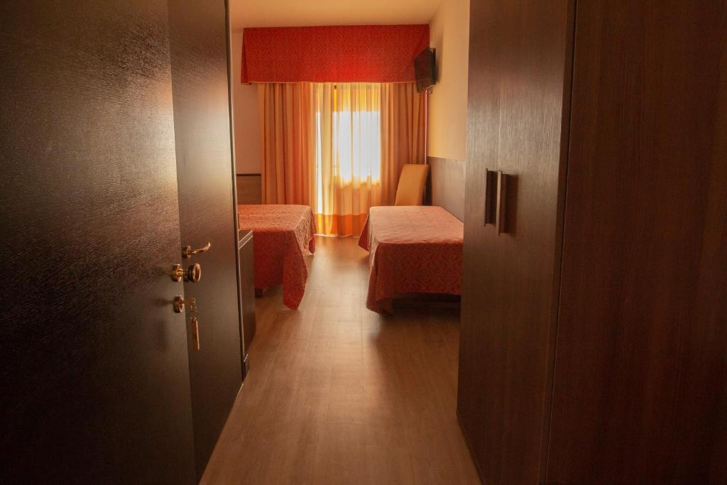 Postel nebo postele na pokoji v ubytování Hotel San Zeno