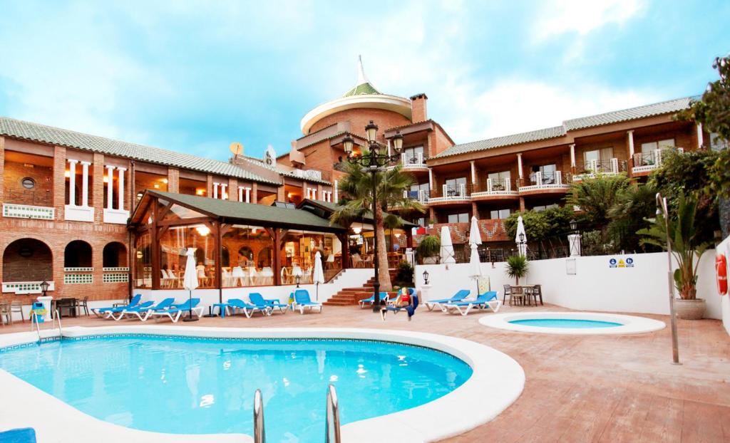 un hotel con piscina frente a un edificio en Hotel Boutique Calas de Alicante, en Alicante