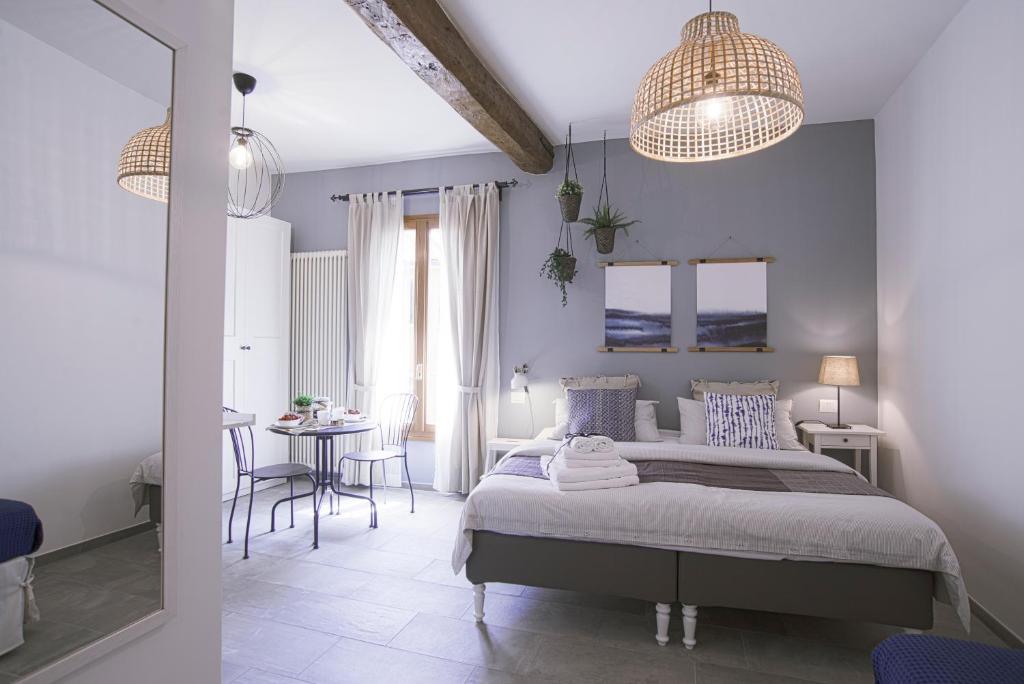 a bedroom with a bed and a table and chairs at B&B Il Viaggio Bologna in Bologna