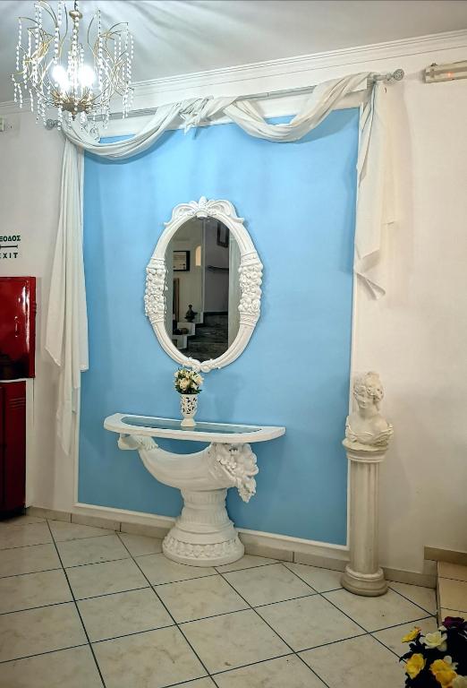 a bathroom with a white sink and a mirror at Thalia deco City & Beach Hotel in Hersonissos