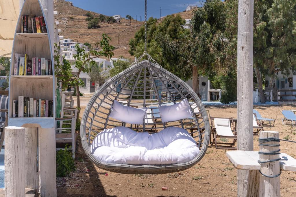 a hammock with pillows and a bed in a yard at Alexandros by the Beach - Serifos in Livadakia