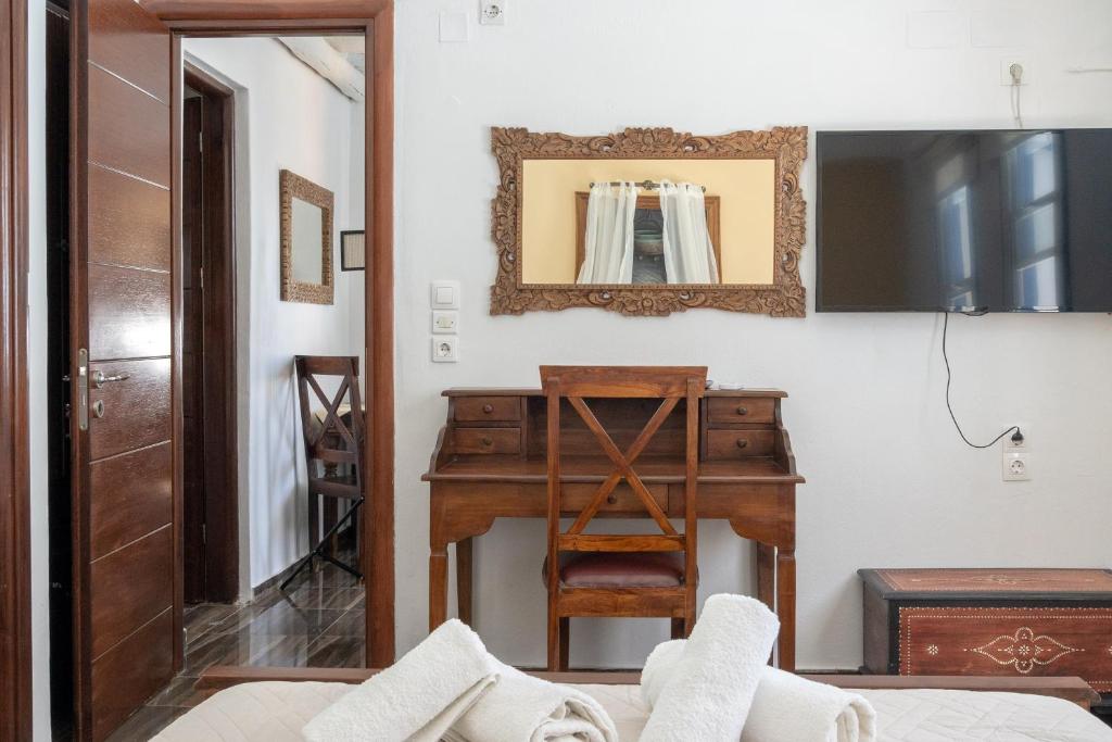 a room with a desk and a mirror at Alexandros by the Beach - Serifos in Livadakia