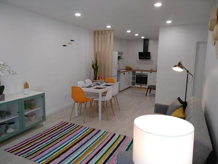 a living room with a couch and a table at Apartamentos Areia e Mar Sul in Vila Praia de Âncora