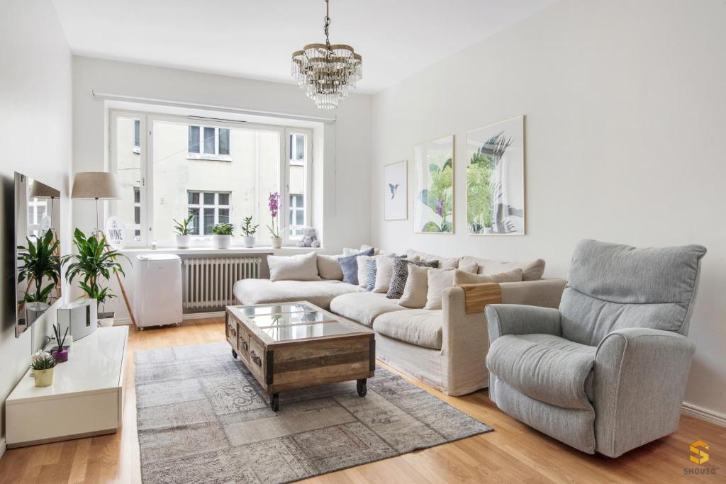 a living room with a couch and a coffee table at WeHost Tarkk'ampujankatu in Helsinki