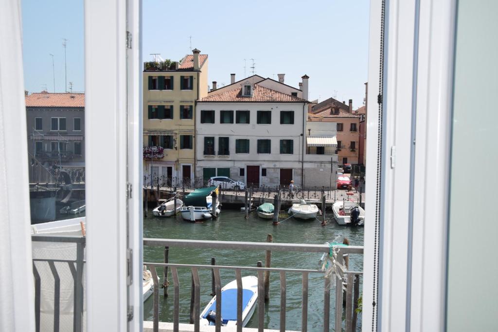 a view of a marina from a window with boats in the water at el Capitan de Mar in Chioggia