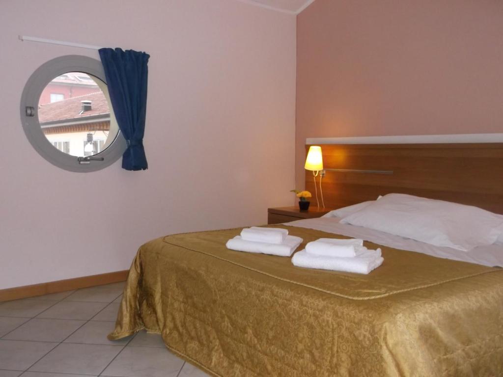 Postel nebo postele na pokoji v ubytování Albergo Meublè Abatjour