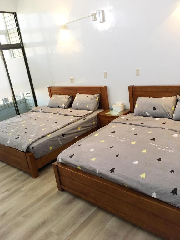 Postel nebo postele na pokoji v ubytování 瑞恒行館Reui Heng Guesthouse