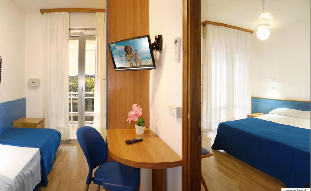 Postel nebo postele na pokoji v ubytování Hotel Bertha Fronte Mare