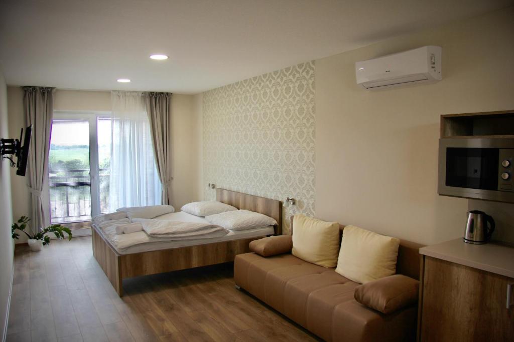 Postel nebo postele na pokoji v ubytování Jazmin apartmány