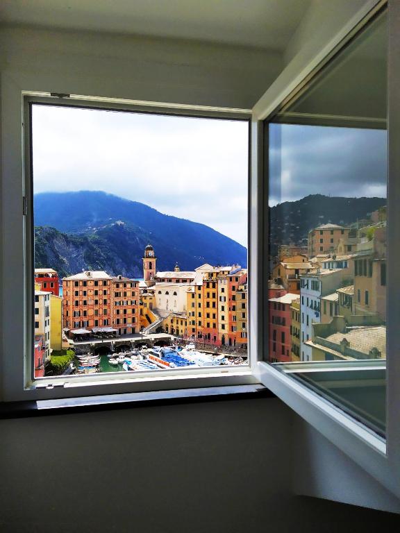 a window in a room with a view of a city at La mansarda sul Porto in Camogli