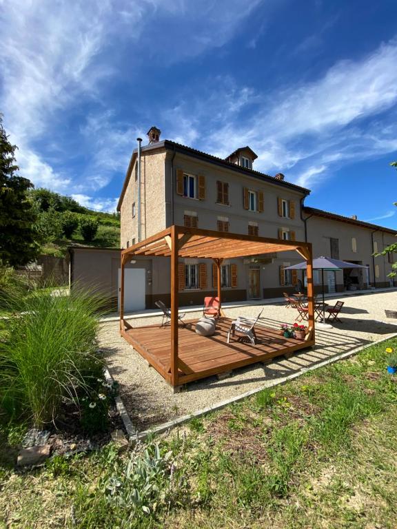 a house with a large deck in front of it at Il Noccioletto in Mombaruzzo