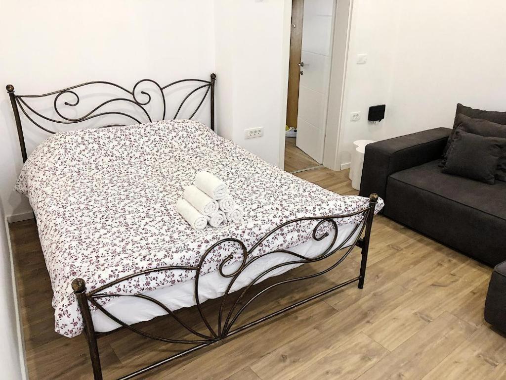 a bed with two pillows on it in a living room at Apartment Mario in Piran