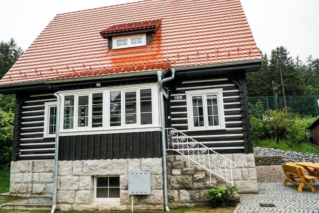 a small house with an orange roof at Dom Franciszkańska 25 in Szklarska Poręba