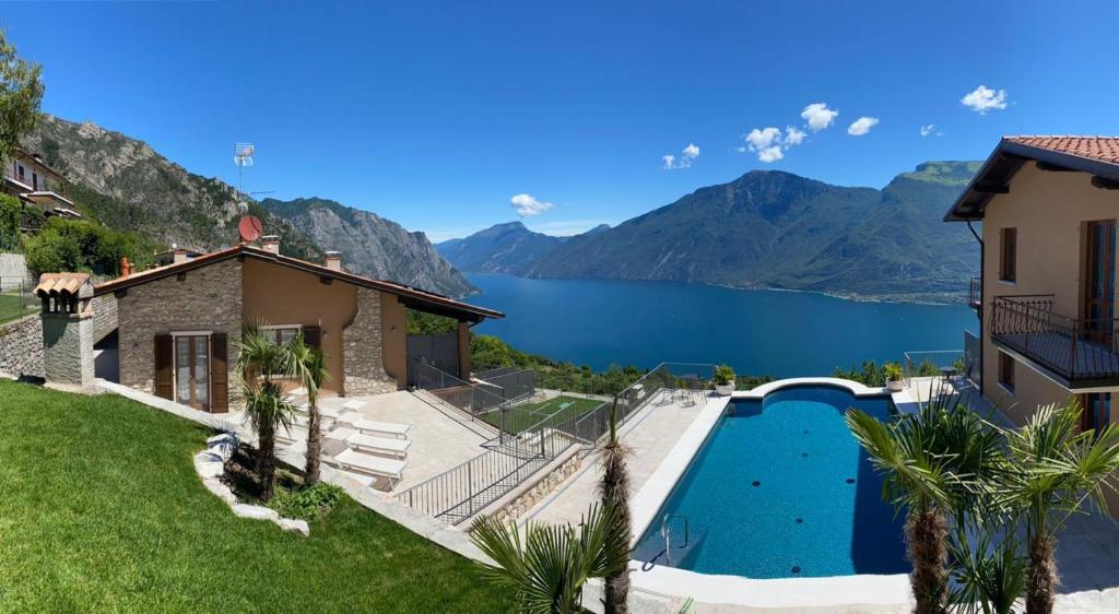 a house with a swimming pool and a view of a lake at CASA MARTINELLI in Tremosine Sul Garda