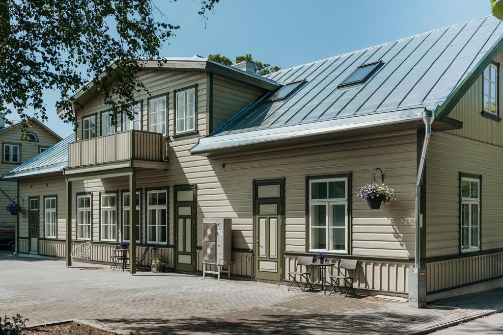 a house with a metal roof and a balcony at Wiigi Apartments in Haapsalu