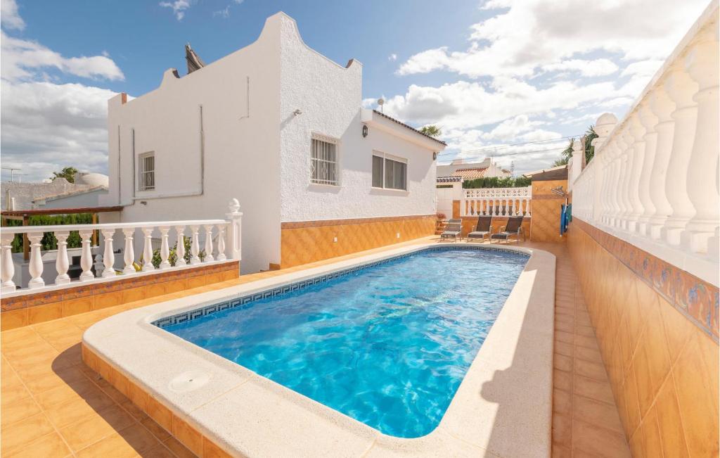 a swimming pool in the backyard of a house at Amazing Home In San Miguel De Salinas With 2 Bedrooms, Wifi And Outdoor Swimming Pool in San Miguel de Salinas