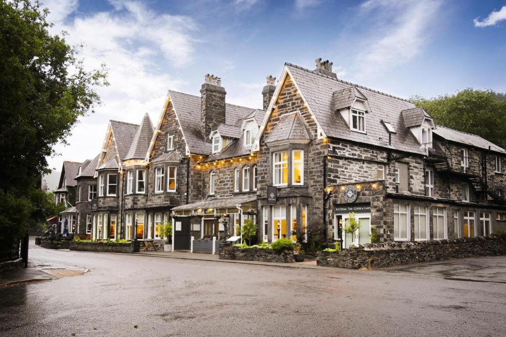 a large building with many windows on a street at Gwydyr Hotel in Betws-y-coed