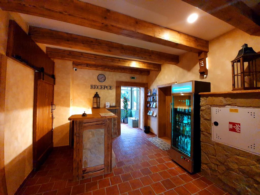 a large room with a bar in a building at Hotel KORTUS in Jetřichovice