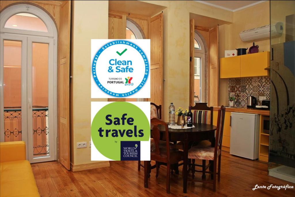 a sign that says clean and safe safe travels in a kitchen at Sao Jorge Apartments & Suites in Lisbon