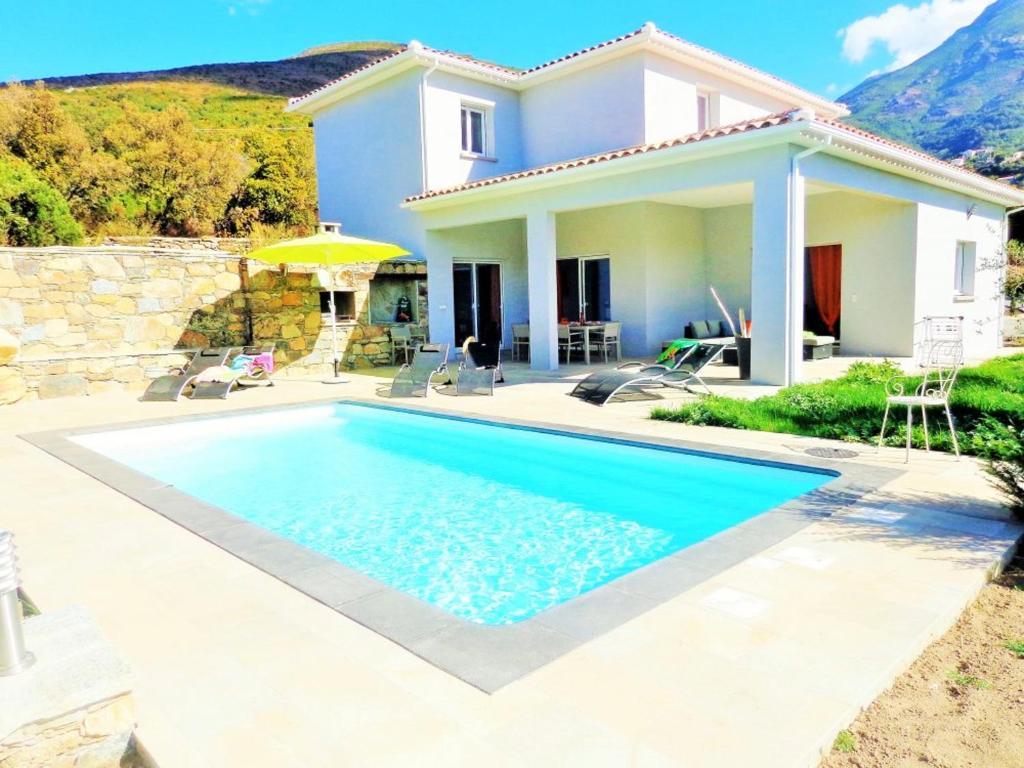 a villa with a swimming pool in front of a house at Villa de 4 chambres a Farinole a 900 m de la plage avec piscine privee jardin amenage et wifi in Farinole