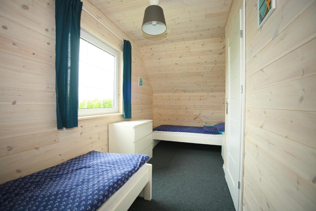 Postel nebo postele na pokoji v ubytování Domki Faro