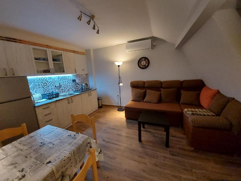 a living room with a couch and a table at Perucac Apartment in Perućac