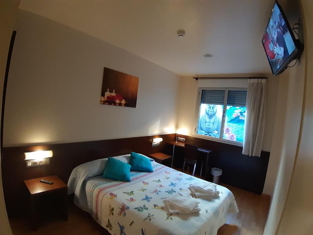 Postel nebo postele na pokoji v ubytování Hostal Nirvana