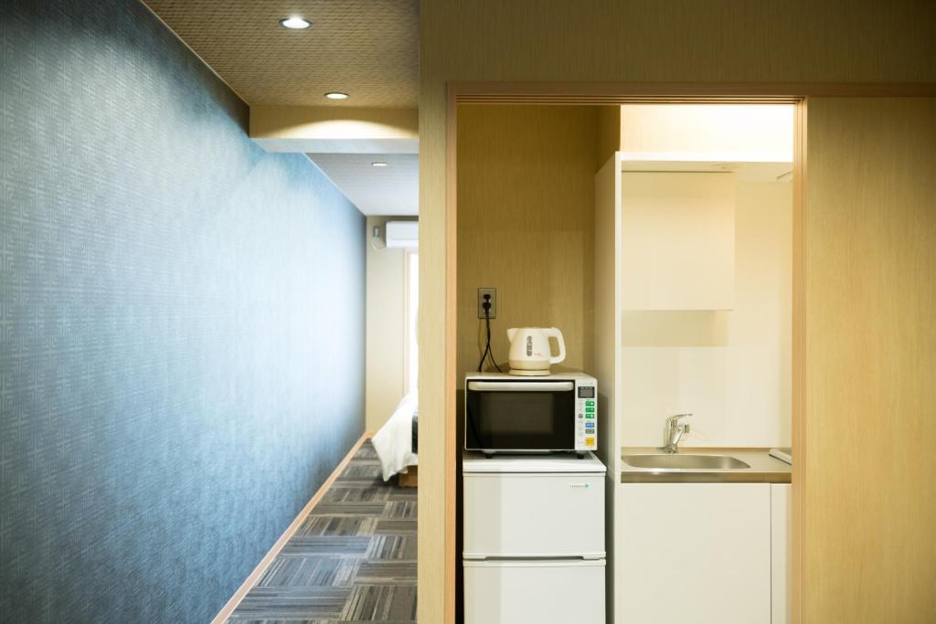 Kuchyň nebo kuchyňský kout v ubytování Shiki Suites - Kyoto Umekoji