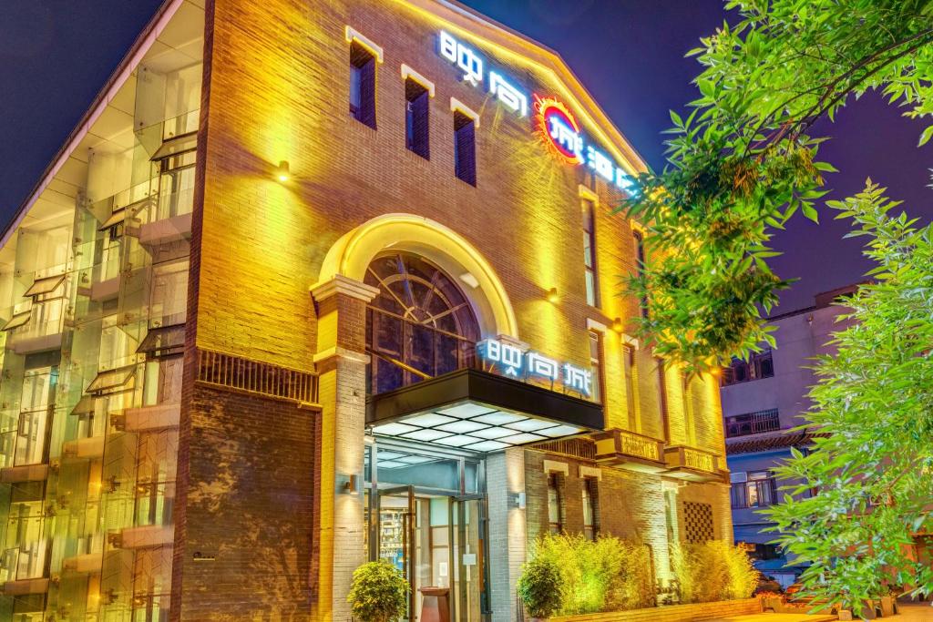 a building with a sign on the side of it at Happy Dragon City Culture Hotel-Tianjin Draum Tower & Dayuecheng shopping mall in Tianjin