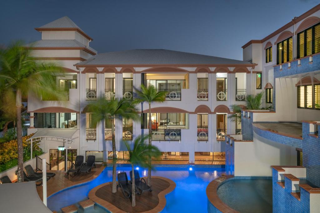 an exterior view of a building with a swimming pool at Regal Port Douglas in Port Douglas