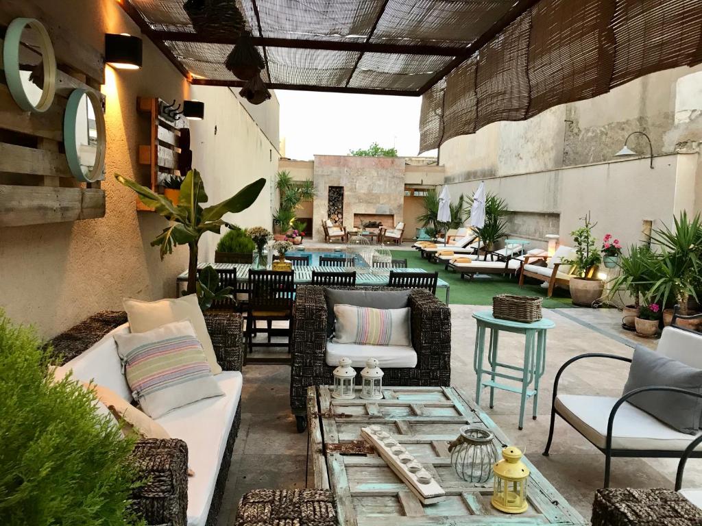 an outdoor patio with couches and a table at Casalaabuelaines in Corral de Calatrava