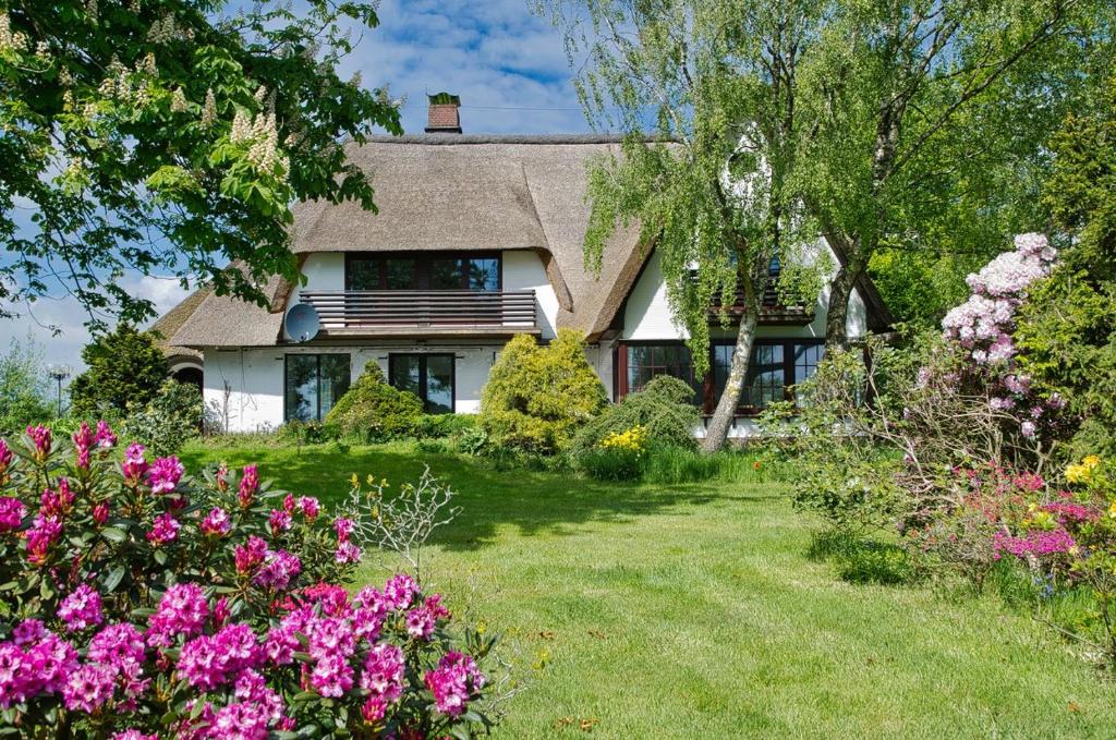 a house with flowers in front of it at "Reetland" - Haus Hartwig in Tating