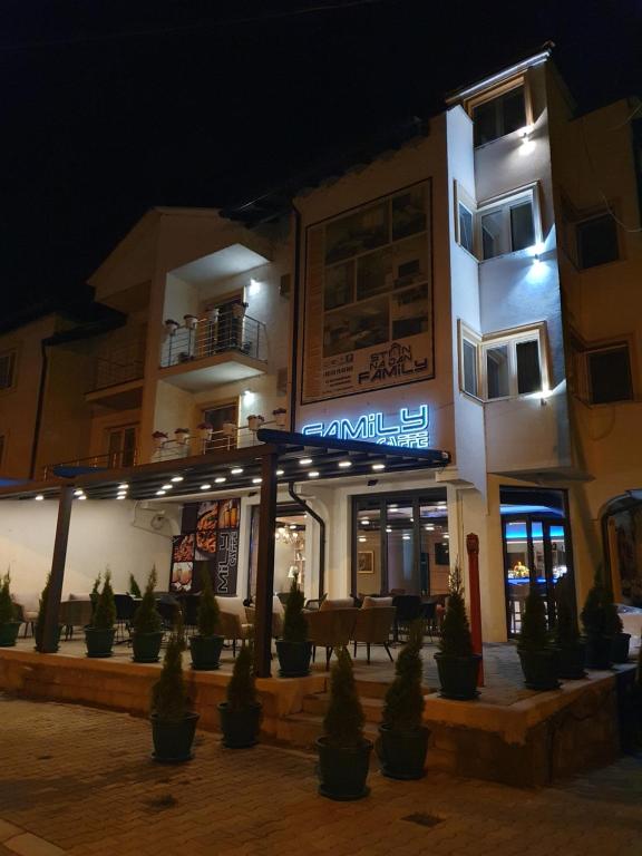 a building with a sign on it at night at Family Apartments in Zaječar