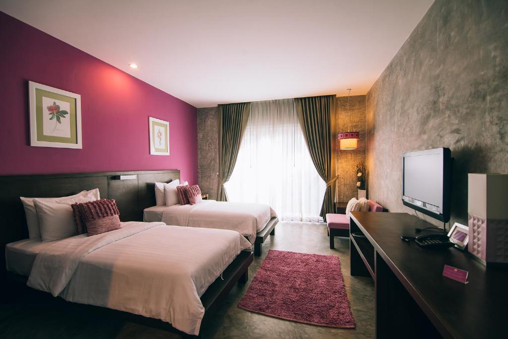 Postel nebo postele na pokoji v ubytování Ketawa Pet Friendly Hotel