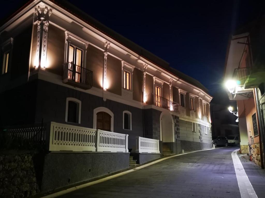 a building with lights on a street at night at Mastu Gilardo in San Pietro al Tanagro