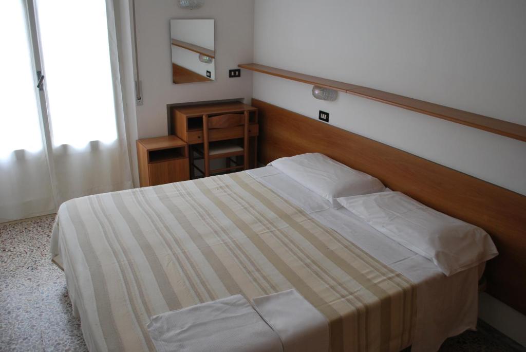 Postel nebo postele na pokoji v ubytování Hotel Numi