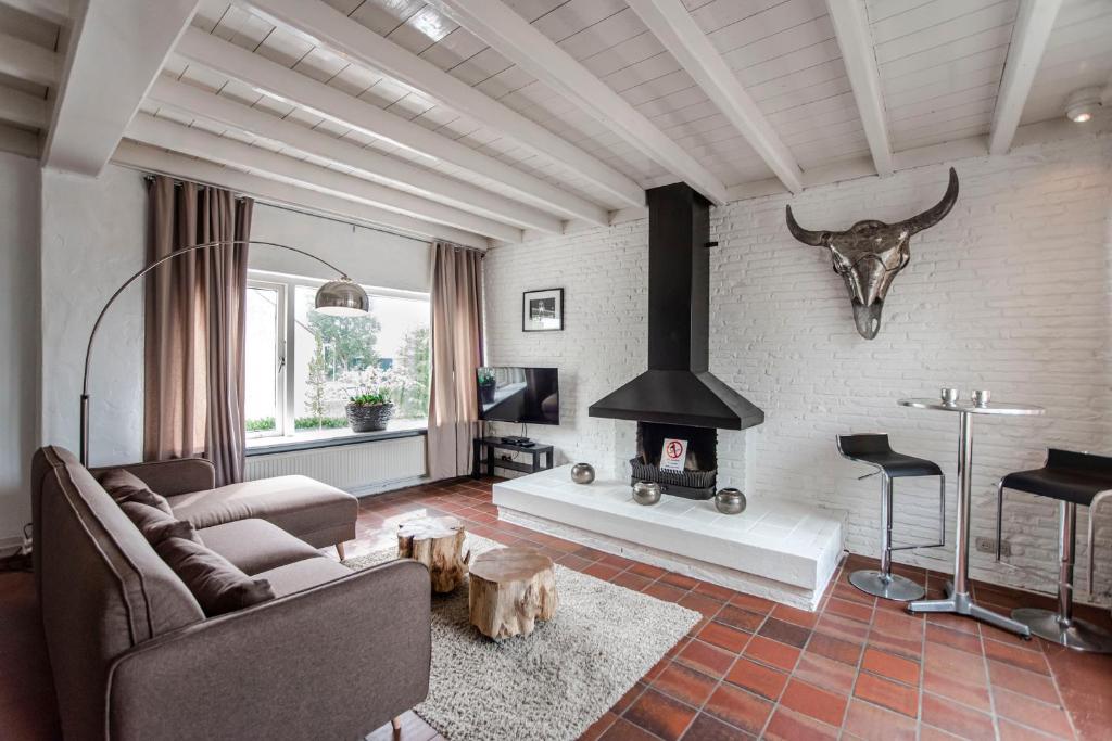 a living room with a couch and a fireplace at Zandvoort North Spacious 2 bedroom apartment in Zandvoort