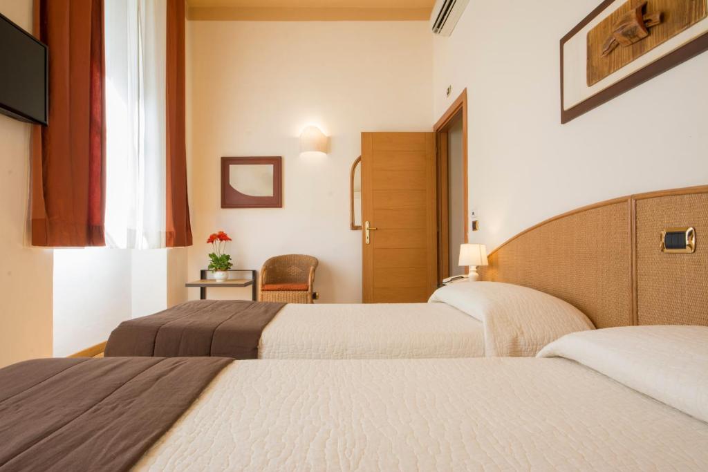 Postel nebo postele na pokoji v ubytování Piazza Paradiso Accommodation
