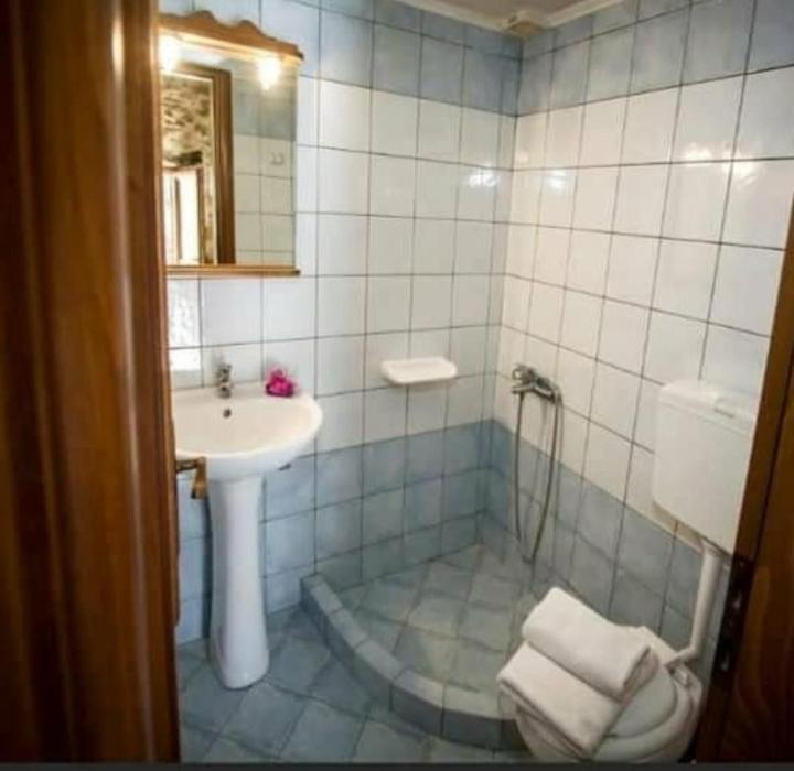 a bathroom with a sink and a toilet and a sink at Luxurious Stone Apartment 1 in Rókka