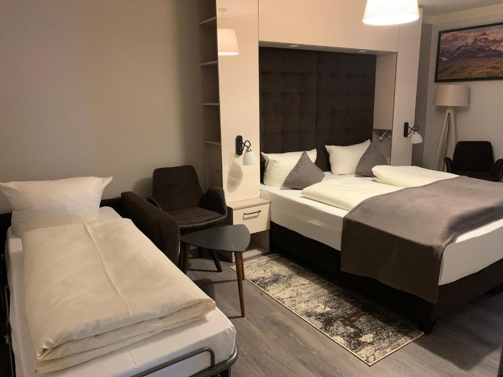 Postel nebo postele na pokoji v ubytování Hotel Bispinger Hof