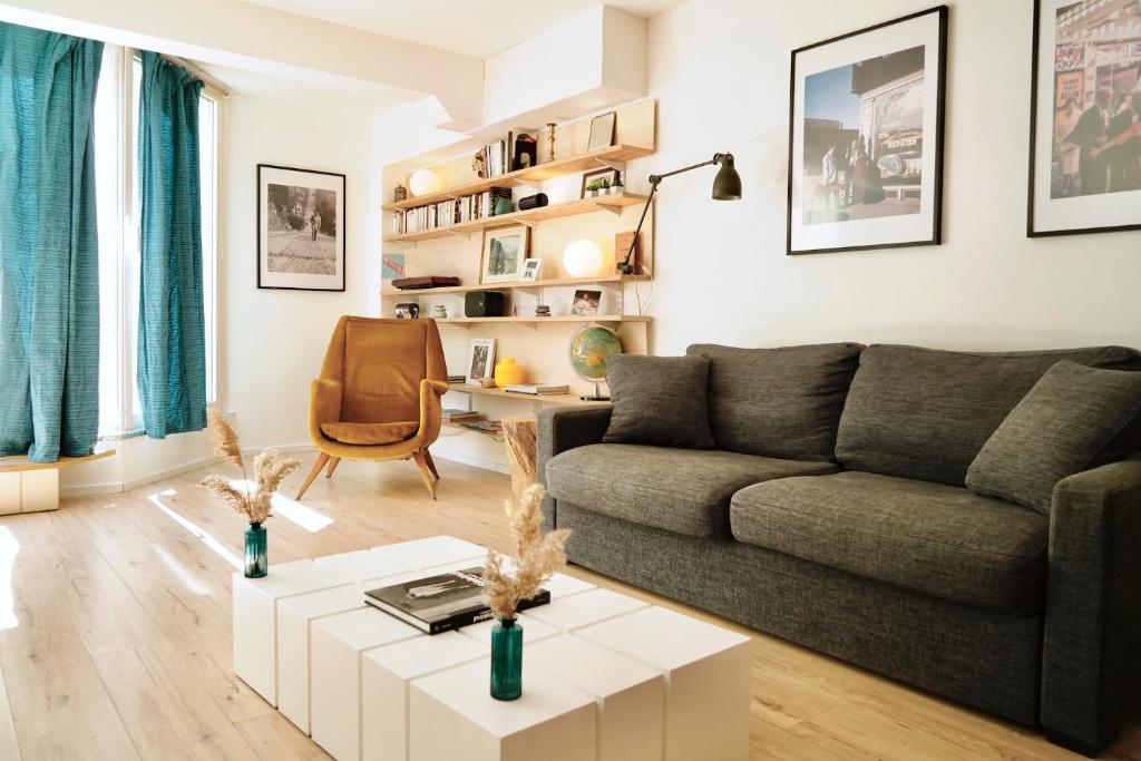 a living room with a couch and a table at Le Saint Roch-Centre-Free Parking-Clim in Montpellier