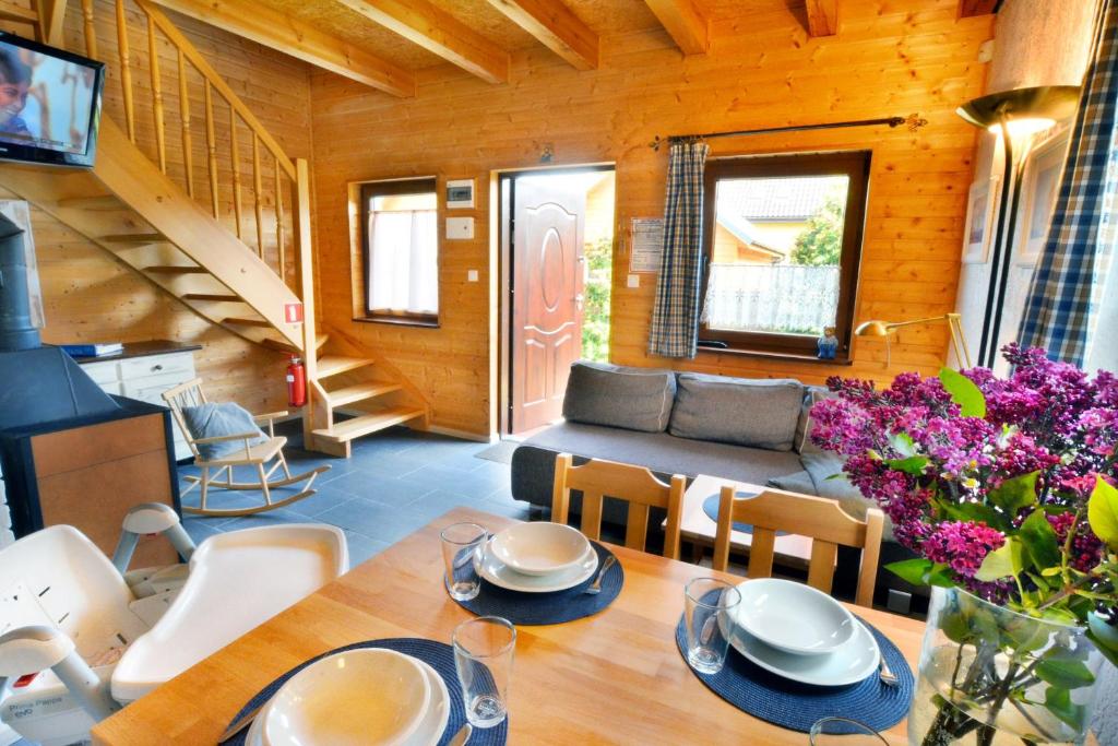 a living room with a table and a couch at Domki Gościniec Bobolin in Bobolin