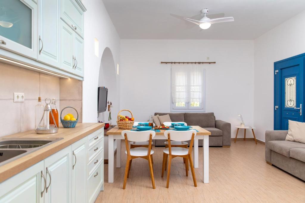 a kitchen and living room with a table and chairs at Oneiric Harmony in Mikri Vigla
